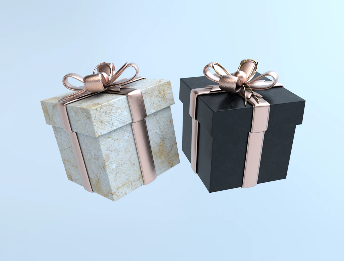 Two gift boxes tied with gold bows